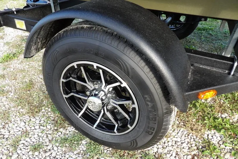 Slide: The Image of Trailer wheel of 2026 Crestliner 1648M CR Jon boat on gravel surface. - 16