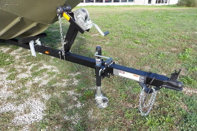 Slide: The Image of Trailer hitch of 2026 Crestliner 1648M CR Jon boat on grassy area. - 18