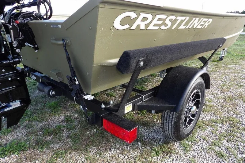 Slide: The Image of 2026 Crestliner 1648M CR Jon boat on trailer, rear view, parked on gravel. - 20