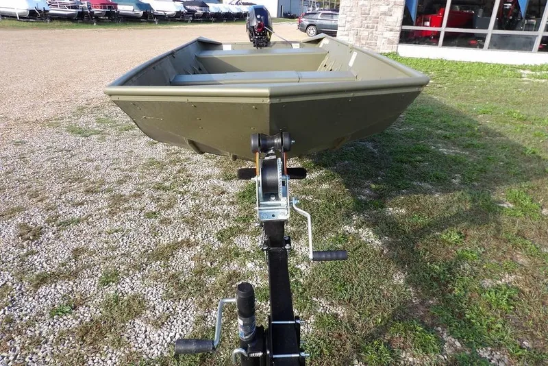 Slide: The Image of 2026 Crestliner 1648M CR Jon boat on trailer, parked on gravel and grass. - 5