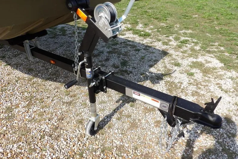 Slide: The Image of Trailer hitch of 2026 Crestliner 1648 CR Jon boat on gravel surface. - 19