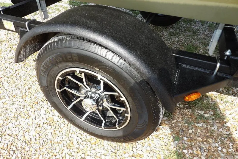 Slide: The Image of Trailer wheel of 2026 Crestliner 1648 CR Jon boat on gravel surface. - 20