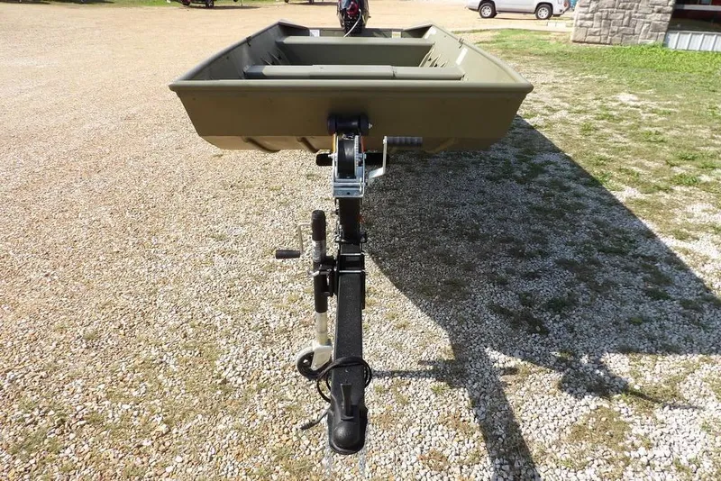 Slide: The Image of 2026 Crestliner 1648 CR Jon boat on trailer, parked on gravel surface. - 3