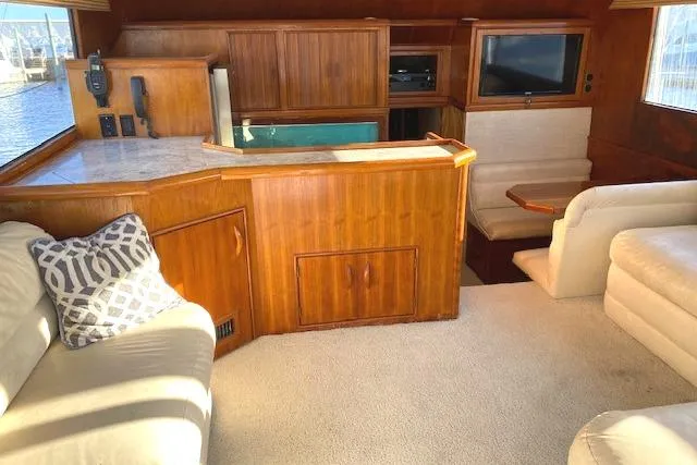 Slide: The Image of Interior of 1988 Buddy Davis 47 Custom Carolina yacht with wood paneling and seating area. - 12