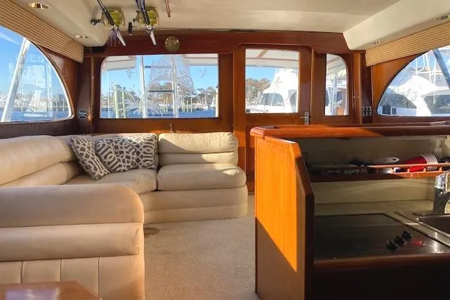 Slide: The Image of Interior of 1988 Buddy Davis 47 Custom Carolina yacht with plush seating and wooden accents. - 15
