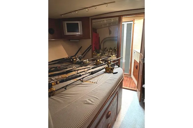 Slide: The Image of Interior of 1988 Buddy Davis 47 Custom Carolina with fishing rods and TV. - 24