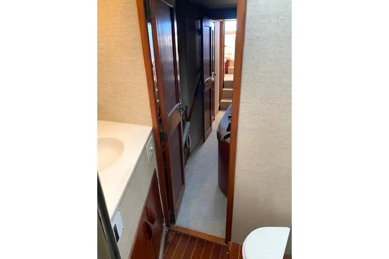 Slide: The Image of Interior view of 1988 Buddy Davis 47 Custom Carolina yacht, featuring hallway and bathroom. - 25