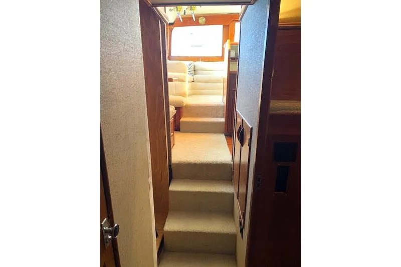 Slide: The Image of Interior of 1988 Buddy Davis 47 Custom Carolina yacht with carpeted stairs and seating area. - 27