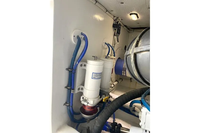 Slide: The Image of Engine room of 1988 Buddy Davis 47 Custom Carolina with filters and hoses. - 41