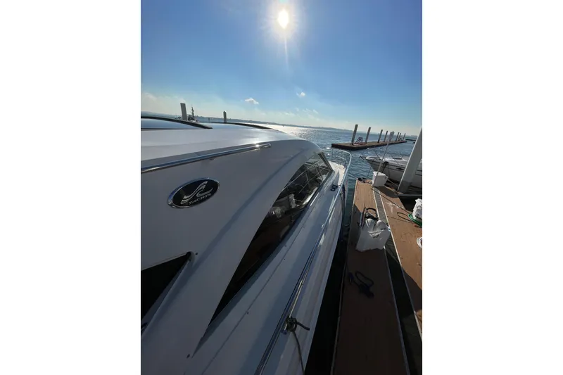 Slide: The Image of 2013 Sea Ray 510 Sundancer yacht docked under bright sun. - 10