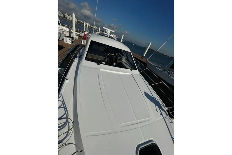 Slide: The Image of 2013 Sea Ray 510 Sundancer yacht docked at marina under clear blue sky. - 19