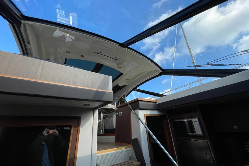 Slide: The Image of Interior view of 2013 Sea Ray 510 Sundancer yacht with open sunroof. - 24