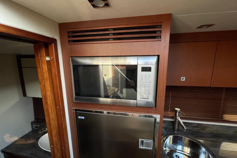 Slide: The Image of Interior of 2013 Sea Ray 510 Sundancer with Cuisinart microwave and modern kitchen amenities. - 29