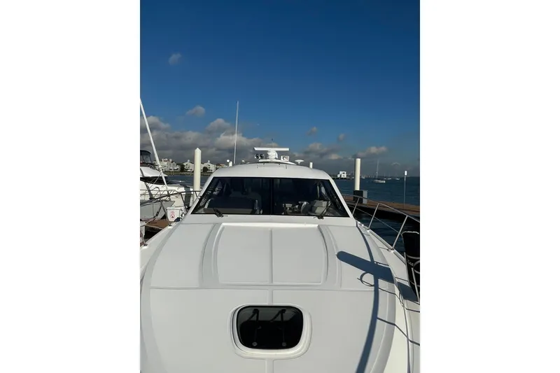 Slide: The Image of 2013 Sea Ray 510 Sundancer yacht docked under a clear blue sky. - 3