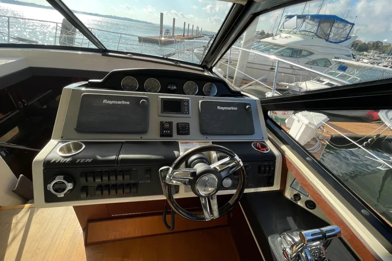 Slide: The Image of Helm of 2013 Sea Ray 510 Sundancer with Raymarine electronics, docked at marina. - 34