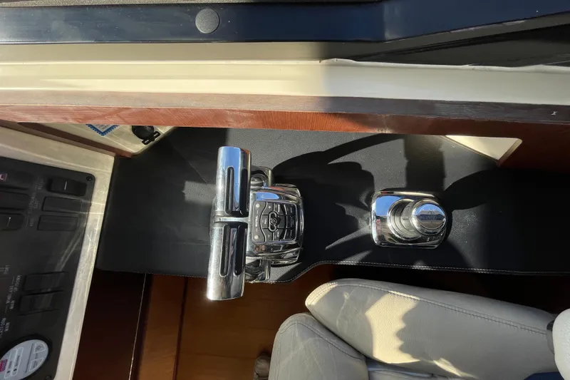 Slide: The Image of Control panel of a 2013 Sea Ray 510 Sundancer yacht, featuring throttle and joystick controls. - 35