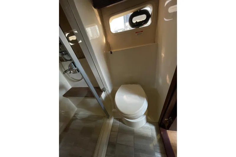 Slide: The Image of Bathroom interior of 2013 Sea Ray 510 Sundancer yacht, featuring toilet and shower. - 42