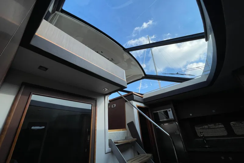 Slide: The Image of Interior view of 2013 Sea Ray 510 Sundancer yacht with open sunroof and modern design. - 46