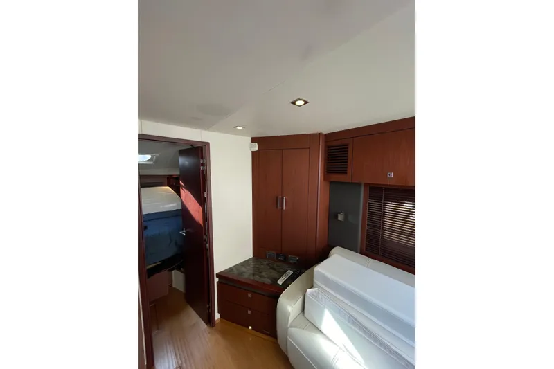 Slide: The Image of Interior of 2013 Sea Ray 510 Sundancer yacht with wood cabinetry and white seating. - 55