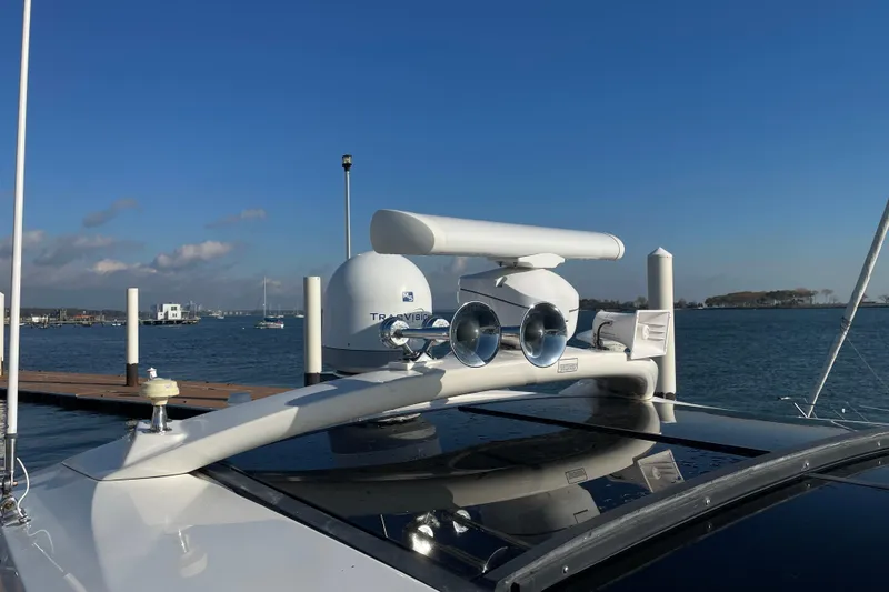 Slide: The Image of 2013 Sea Ray 510 Sundancer yacht with radar and antennas, docked by the water. - 6
