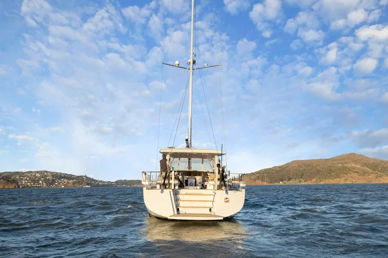 Slide: The Image of Sailing yacht Hylas H57 (2020) on open water with scenic coastal backdrop. - 18