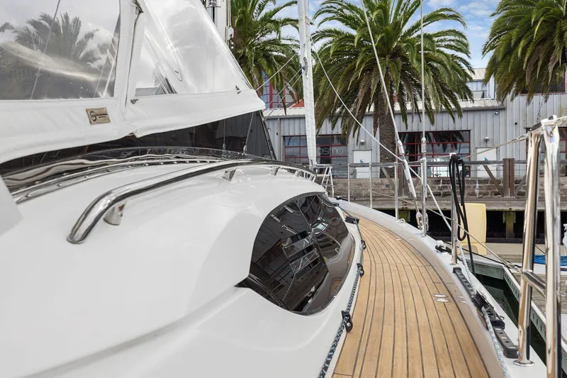 Slide: The Image of 2020 Hylas H57 yacht docked, showcasing sleek design and wooden deck. - 42