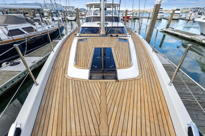 Slide: The Image of Luxurious 2020 Hylas H57 yacht with sleek wooden deck, docked in a marina. - 47
