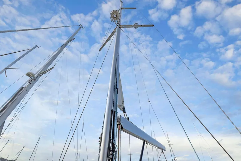 Slide: The Image of Sailboat mast of 2020 Hylas H57 against a blue sky with clouds. - 53