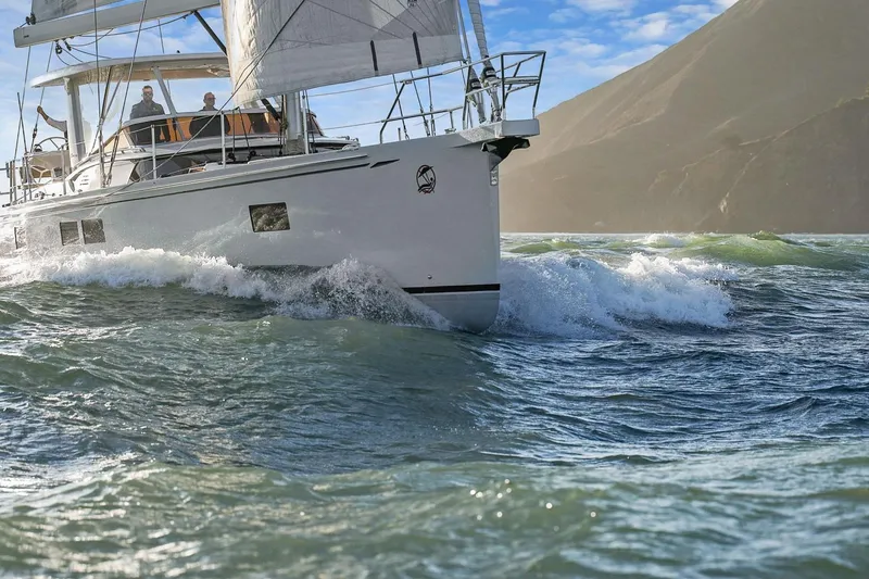 Slide: The Image of Sailing yacht Hylas H57 (2020) navigating waves with mountainous backdrop. - 8