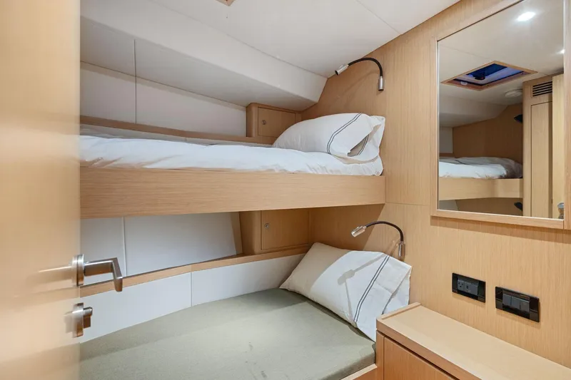 Slide: The Image of 2020 Hylas H57 yacht cabin with bunk beds and modern wooden interior. - 88
