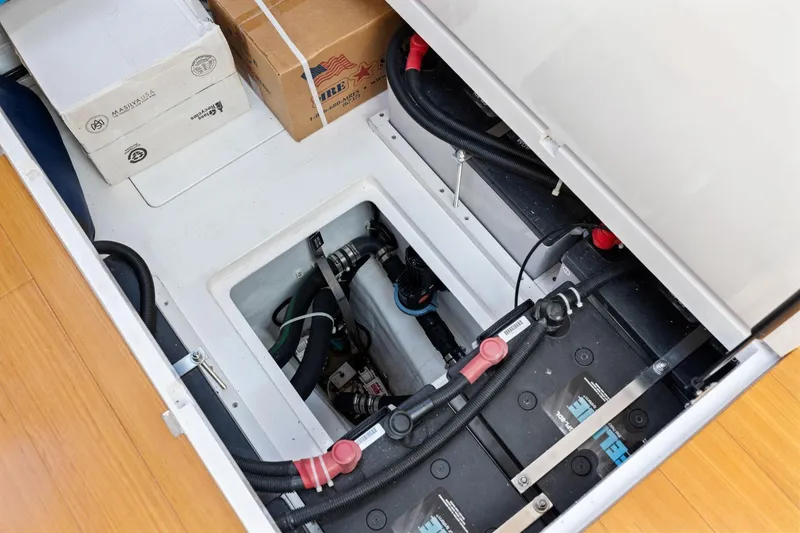 Slide: The Image of 2020 Hylas H57 yacht interior showing battery compartment and wiring setup. - 90