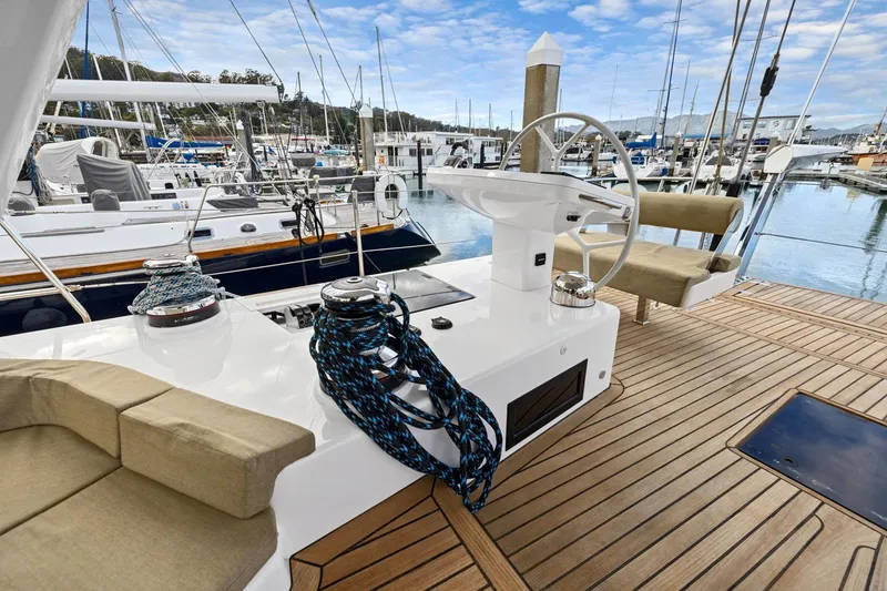 Slide: The Image of Luxurious 2020 Hylas H57 yacht deck with steering wheel and marina view. - 38