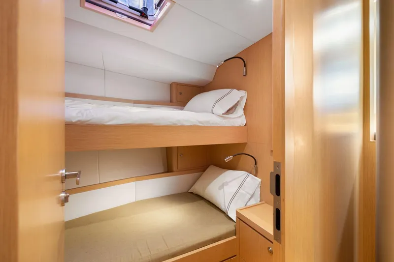 Slide: The Image of Cozy bunk beds in 2020 Hylas H57 yacht cabin with natural wood finish. - 87