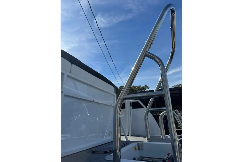 Slide: The Image of 2026 JC Spirit 222 TT Sport boat with sleek metal railings under a clear blue sky. - 12
