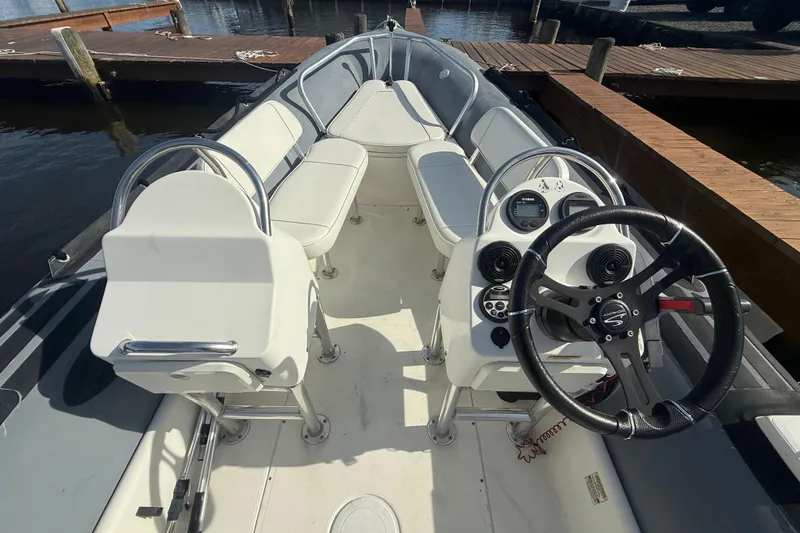 Slide: The Image of 2012 Zodiac Bayrunner Pro 650 boat interior with steering wheel and seating. - 10