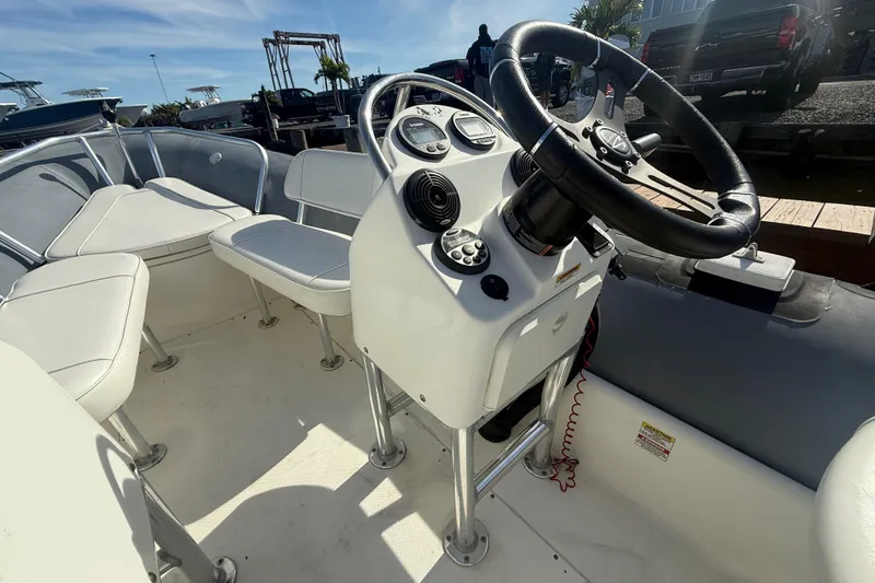 Slide: The Image of 2012 Zodiac Bayrunner Pro 650 boat interior with steering console and seating. - 13