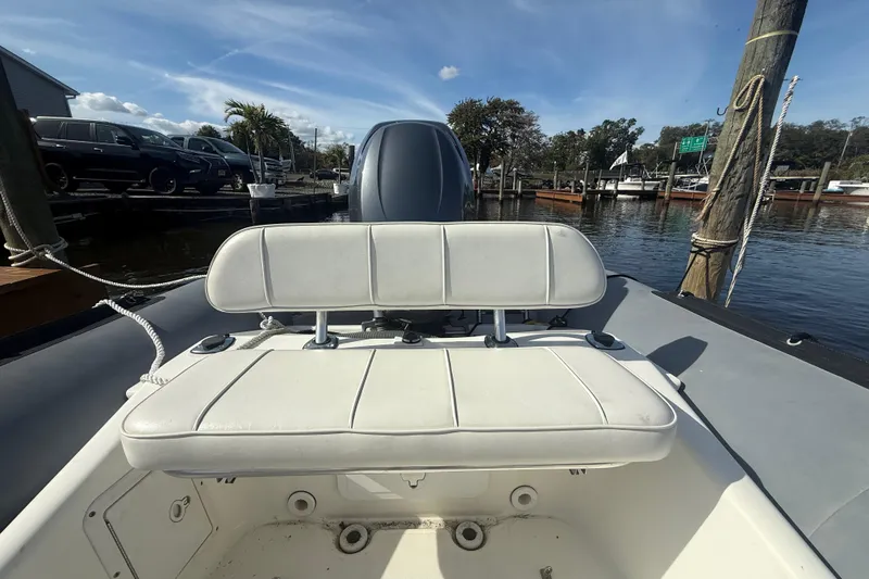 Slide: The Image of 2012 Zodiac Bayrunner Pro 650 boat with white seating, docked by the water. - 14