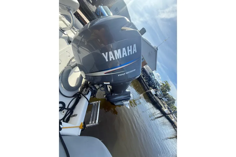Slide: The Image of 2012 Zodiac Bayrunner Pro 650 with Yamaha outboard motor at dockside. - 16
