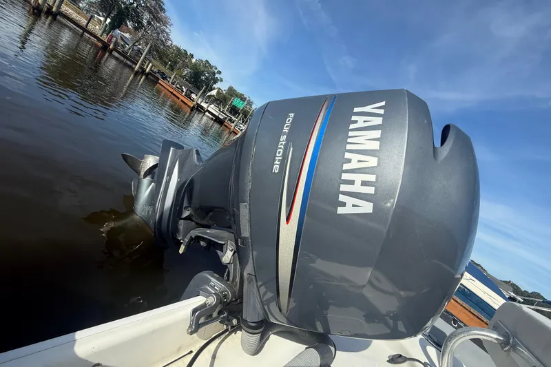 Slide: The Image of Yamaha outboard motor on 2012 Zodiac Bayrunner Pro 650 boat, docked by the water. - 17