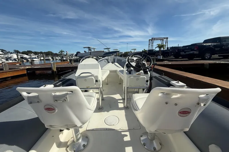 Slide: The Image of 2012 Zodiac Bayrunner Pro 650 boat interior with white seats and steering wheel. - 8