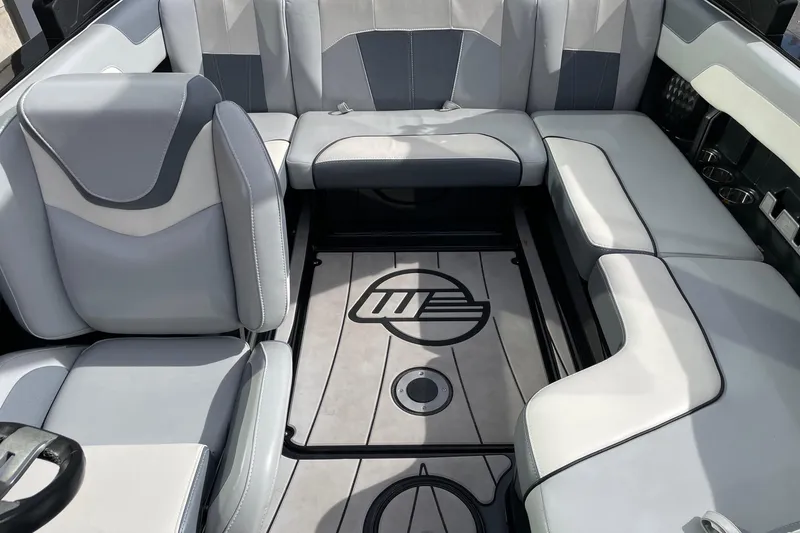 Slide: The Image of 2023 Malibu Wakesetter 20 VTX interior with sleek gray seating and custom flooring. - 12