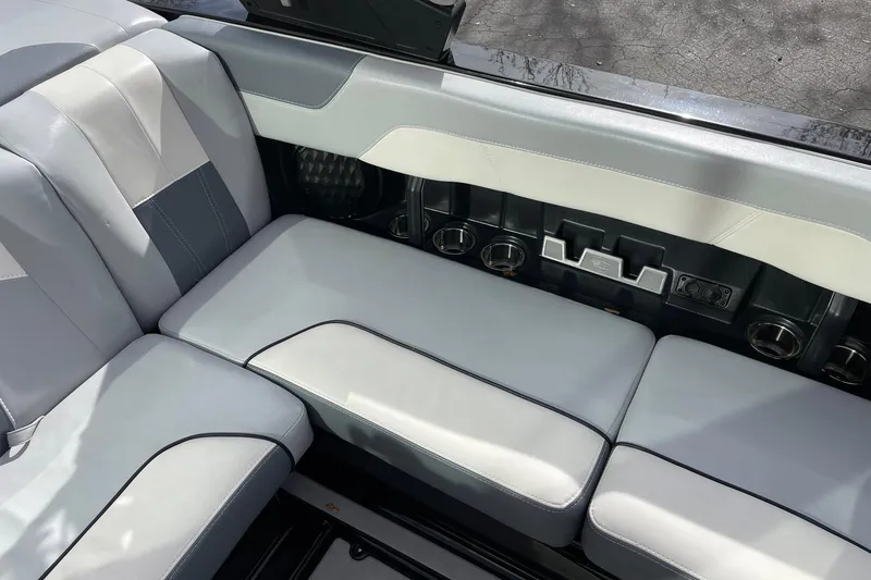 Slide: The Image of 2023 Malibu Wakesetter 20 VTX interior seating with cup holders and sleek design. - 9