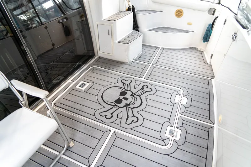 Slide: The Image of 2000 Carver 450 Voyager Pilothouse deck with skull and crossbones design. - 14