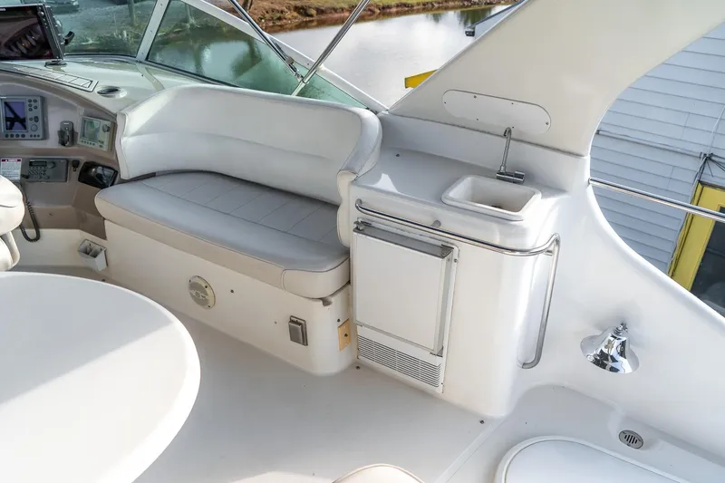 Slide: The Image of 2000 Carver 450 Voyager Pilothouse interior with seating, sink, and control panel. - 19