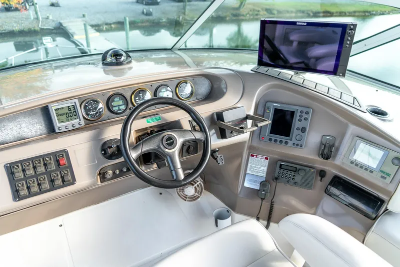 Slide: The Image of 2000 Carver 450 Voyager Pilothouse helm with navigation instruments and steering wheel. - 22