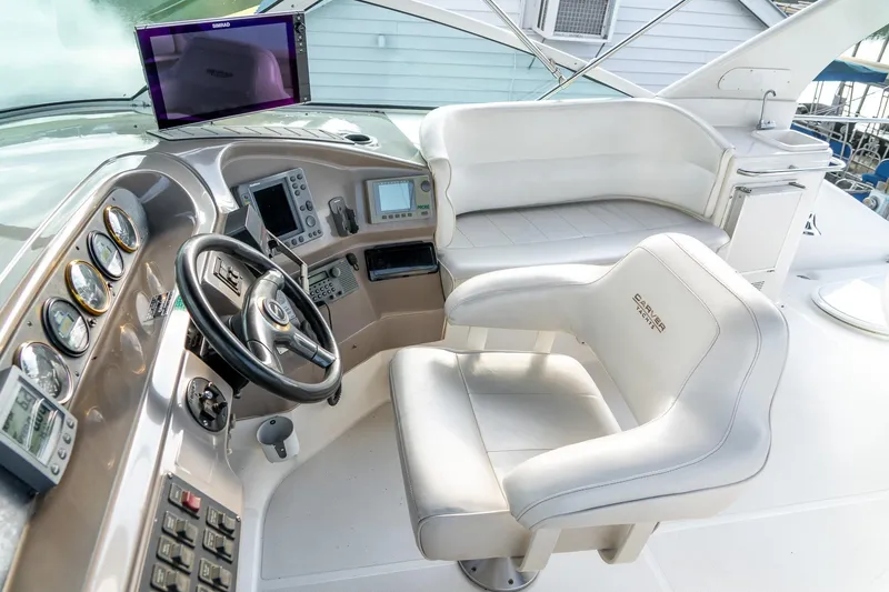 Slide: The Image of Pilothouse of 2000 Carver 450 Voyager with steering wheel, gauges, and seating. - 23