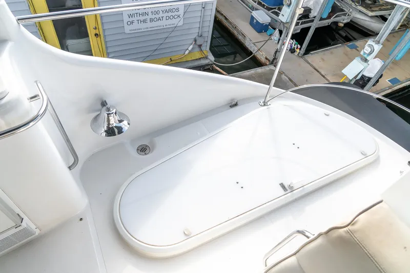 Slide: The Image of 2000 Carver 450 Voyager Pilothouse deck with chrome light and railing. - 28