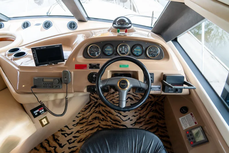 Slide: The Image of Pilothouse interior of 2000 Carver 450 Voyager with steering wheel and navigation instruments. - 39