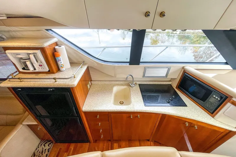 Slide: The Image of Luxurious kitchen interior of 2000 Carver 450 Voyager Pilothouse yacht with modern amenities. - 53