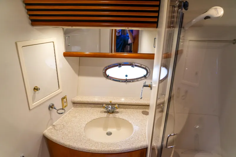 Slide: The Image of Bathroom interior of 2000 Carver 450 Voyager Pilothouse with sink and porthole window. - 61